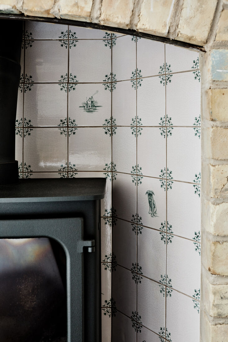 the delft style hearth tiles, in green rather than the traditional blue, are th 17