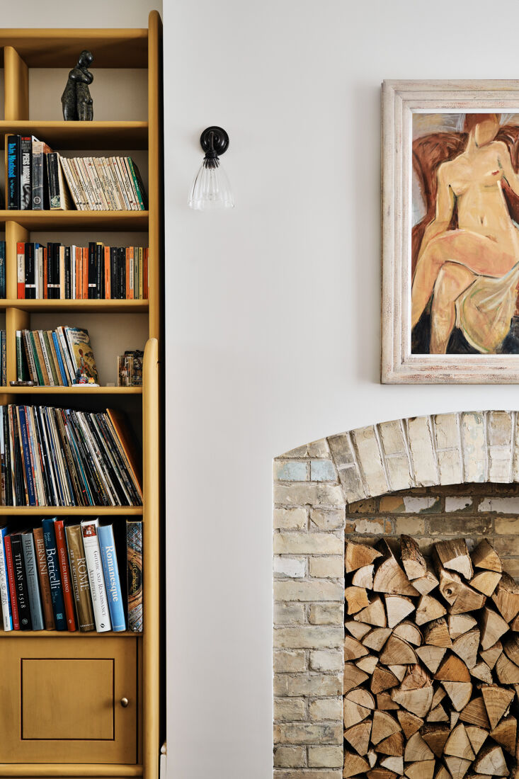 a built in bookshelf and hearth for storing firewood in the study. 23