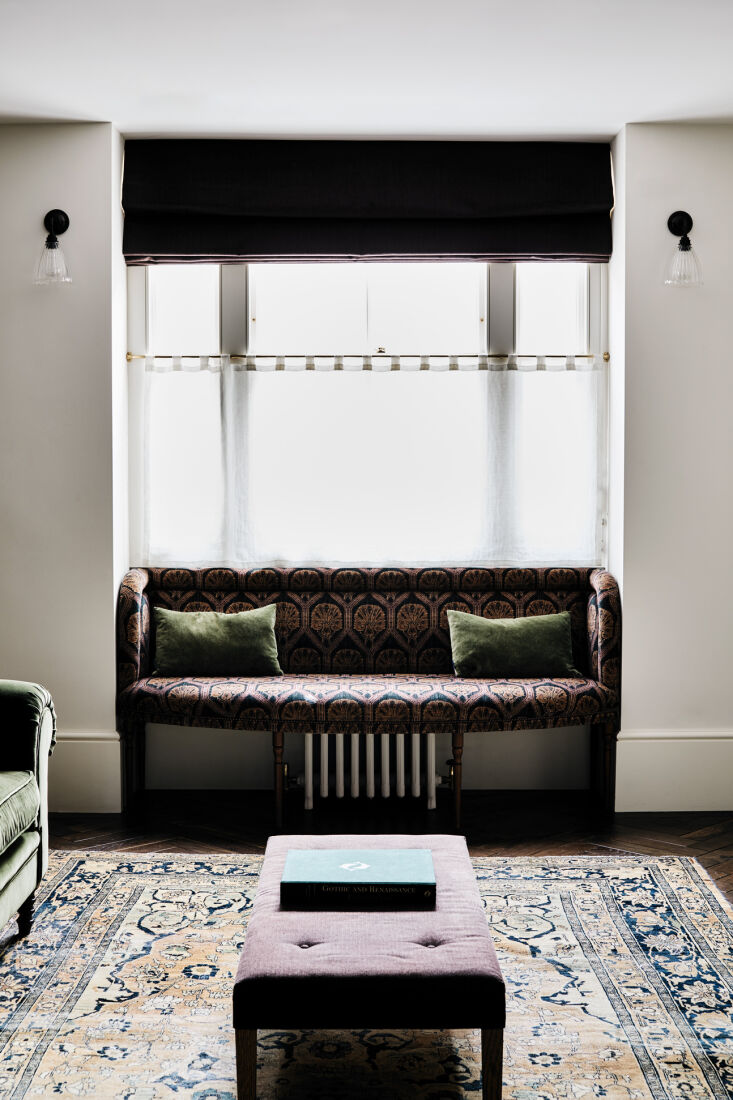a window seat is upholstered in a robert kime velvet. 18