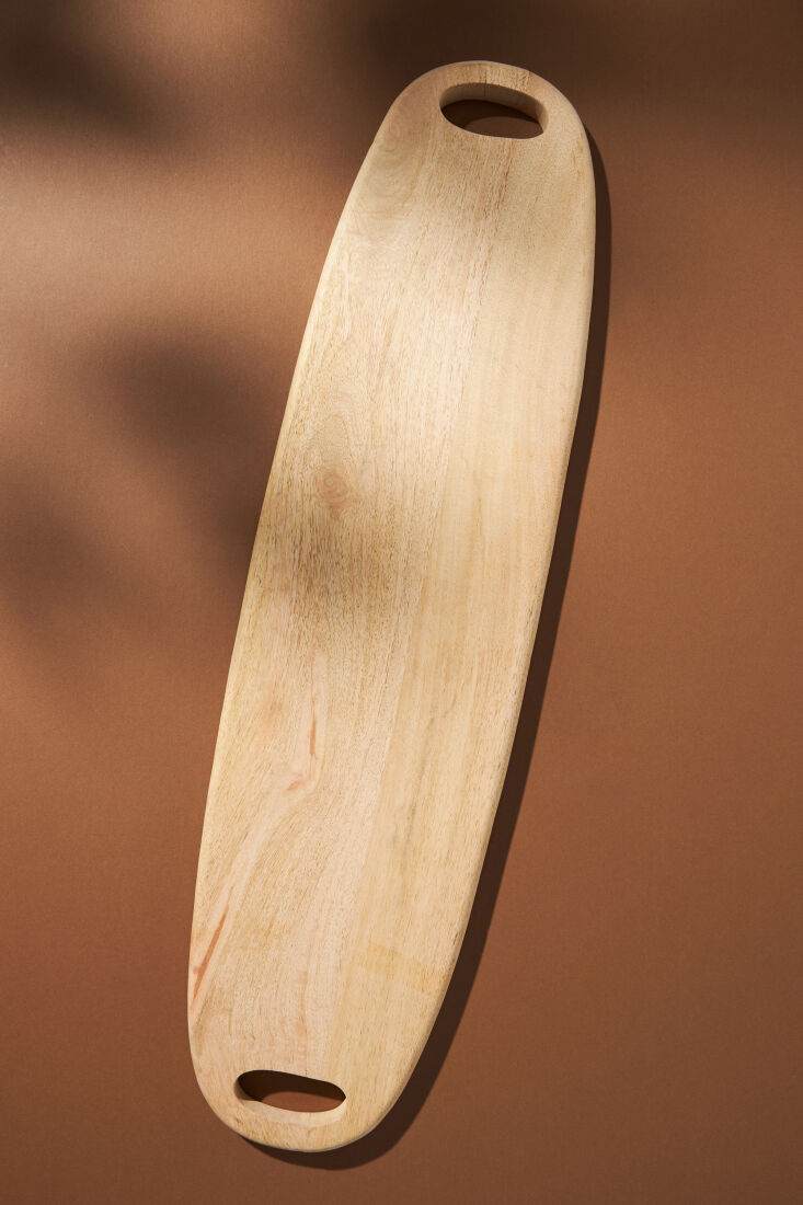 above: the handcrafted oval wood serving board (\$98) makes a practical gift fo 13