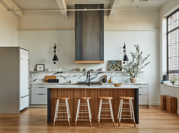 the kitchen is oriented perpendicular to a bank of north facing metal framed wi 9