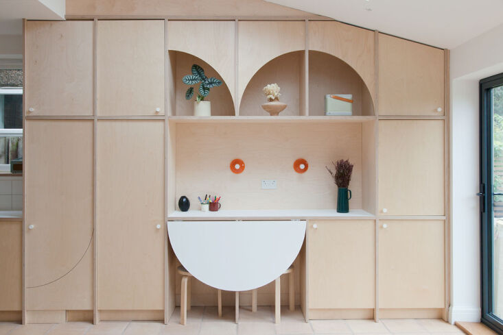 this wall of storage cabinets includes a fold out table that the kids currently 12
