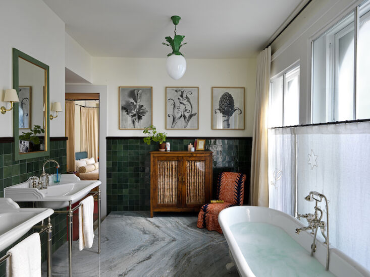 the main bathroom with granite flooring, and a vintage slipper chair covered in 21