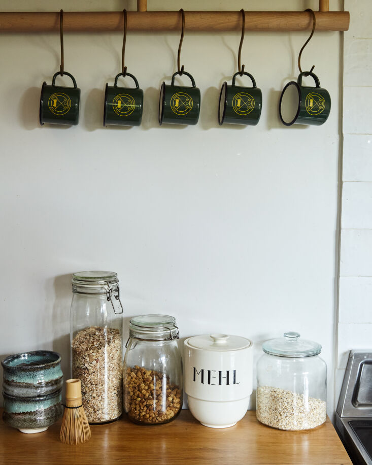 dowels under the open shelves provide extra storage for key items, including en 13
