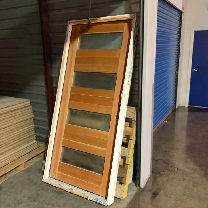 a solid hardwood door with frosted glass panels in a red gold maple finish rece 23