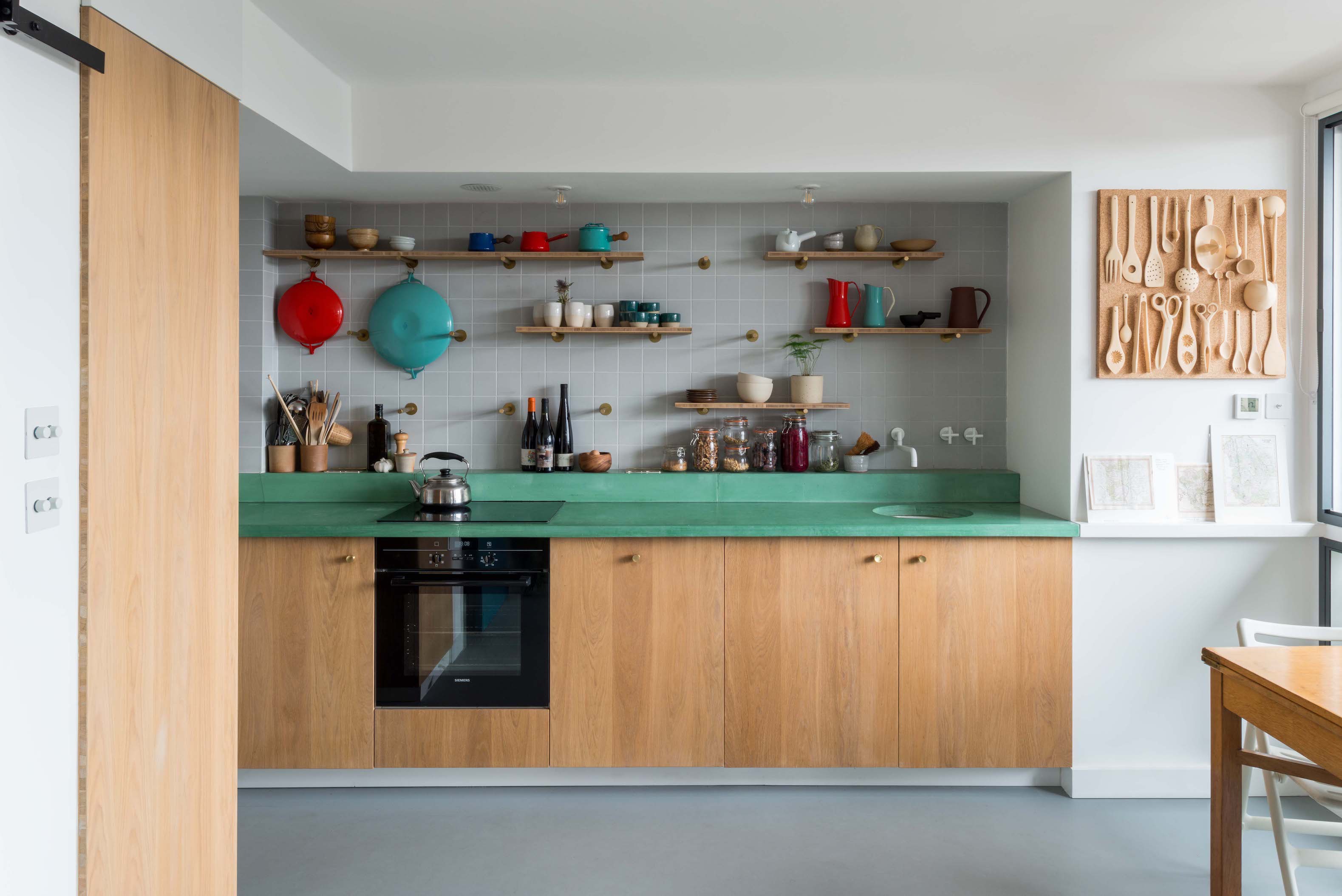 the kitchen is designed with cabinets in oak triply, a three layered plywood, a 9