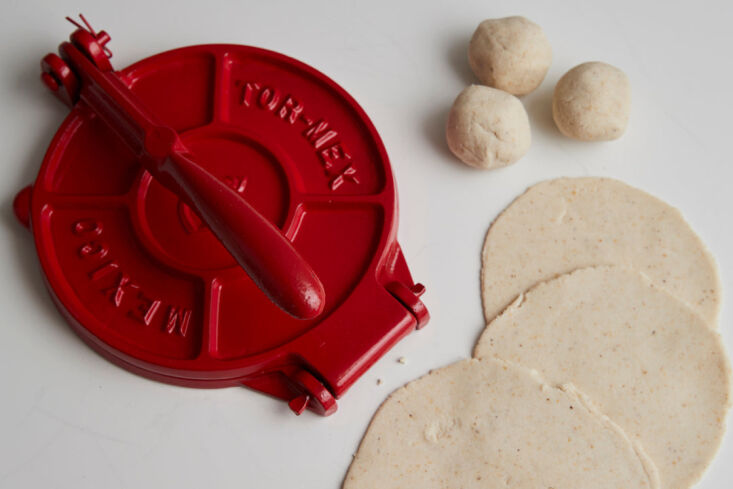 the red cast iron tortilla press is made in mexico from upcycled singer sewing  13