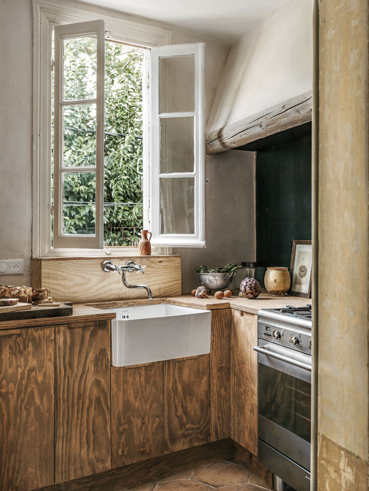 the moores installed a compact, stained plywood kitchen with a preserved french 10