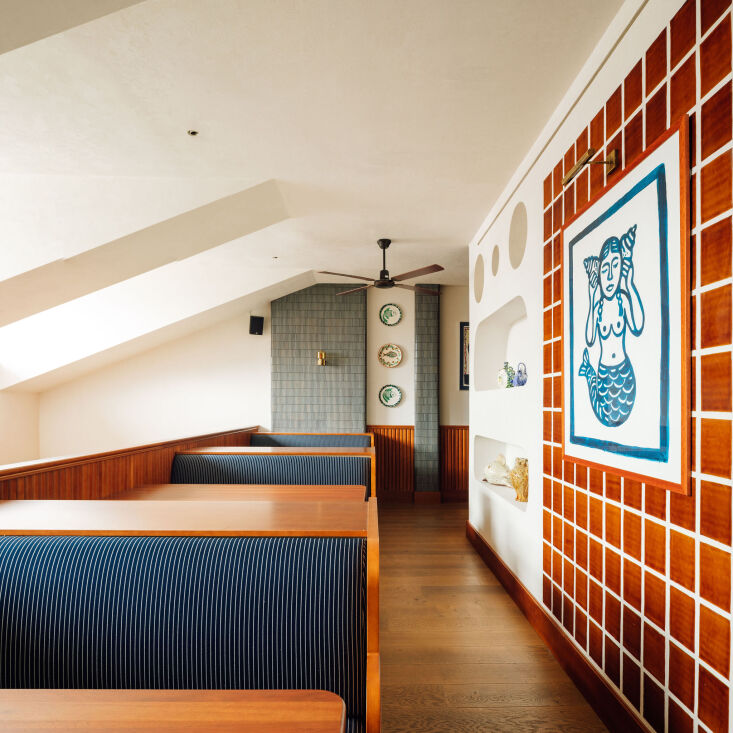 above; upstairs, the space feels particularly nautical, with blue tiles on the  19