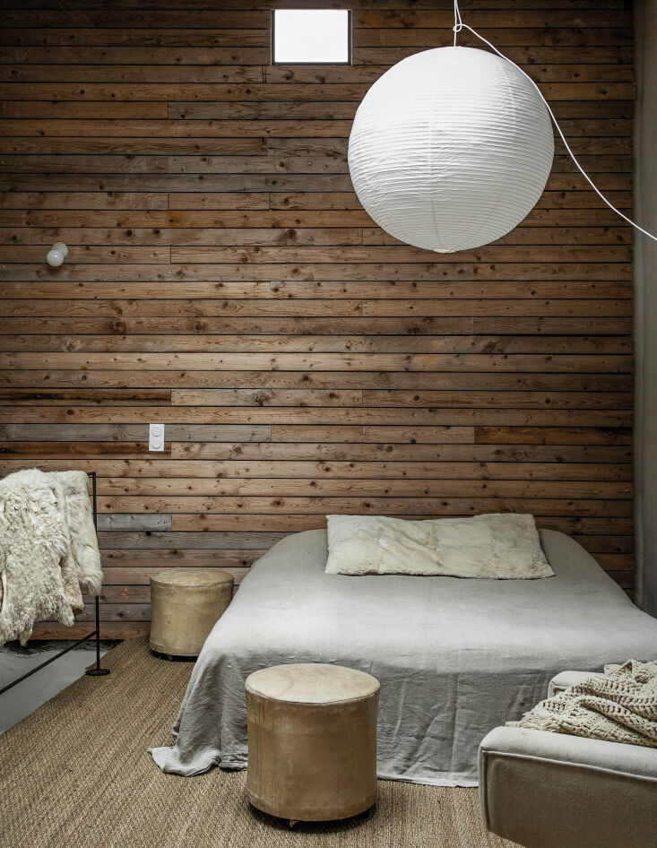 in one of the bedrooms, the moores introduced a paneled wood wall as &#8\2\ 13
