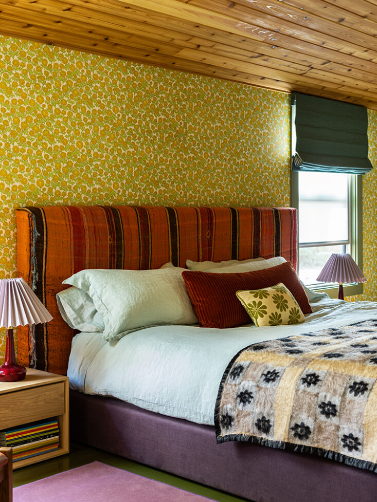 the green lavender rust color palette extends into the main bedroom. here, a re 19