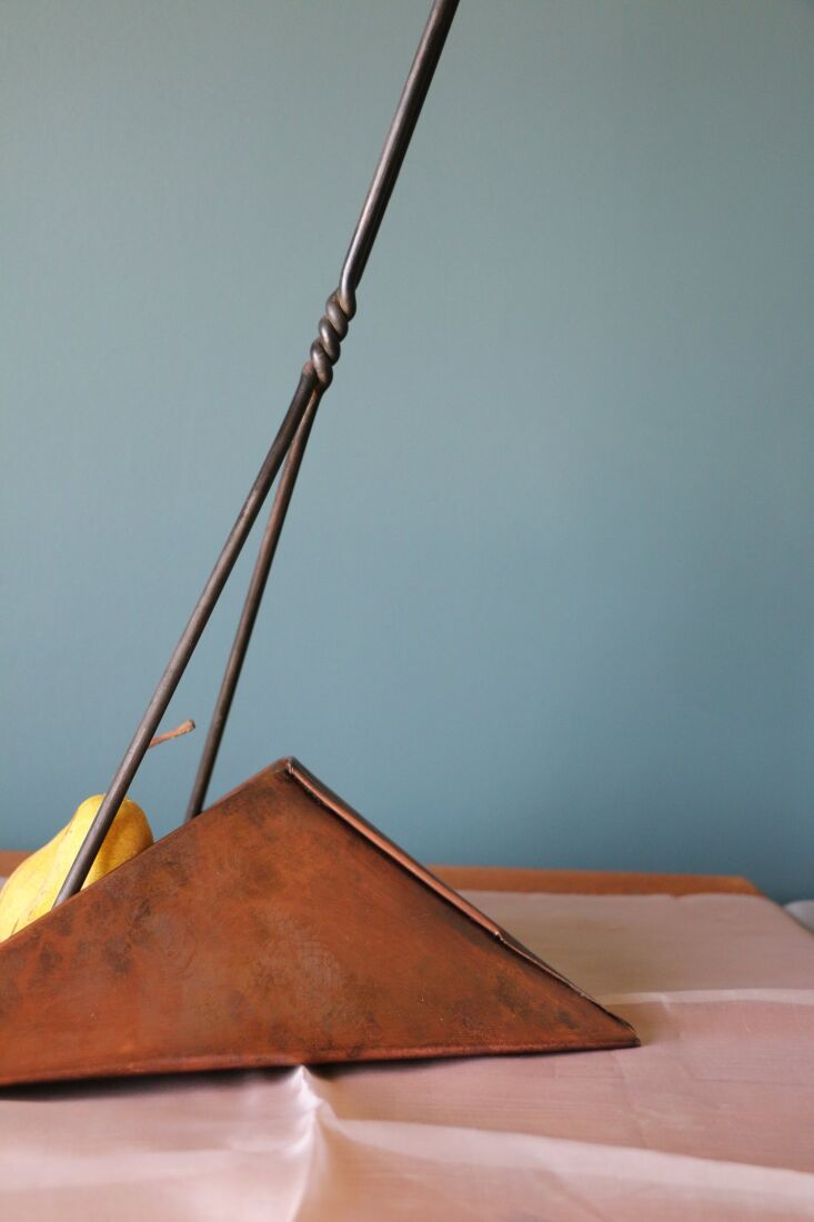 the dustpan is a solid copper pan with a long twisted steel handle, no crouchin 10