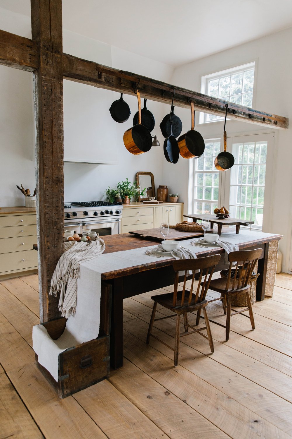 pots and pans hang above the central kitchen island/table. photography by erin  10