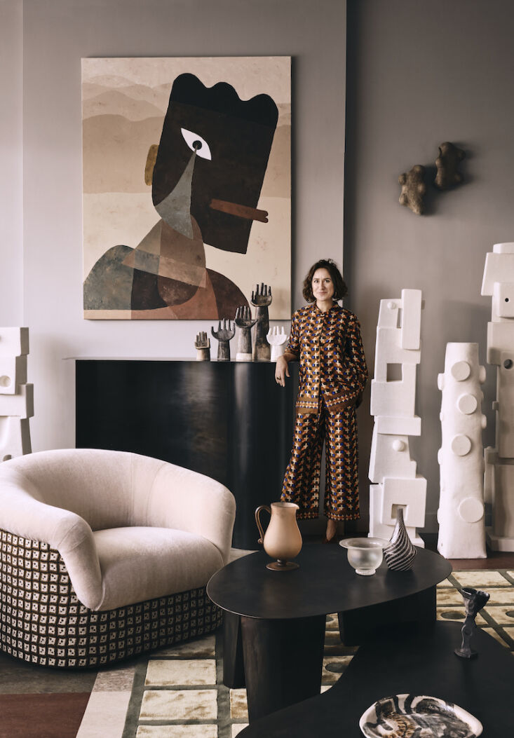 laura fulmine  d in the living area next to a sculptural fireplace made for the 9