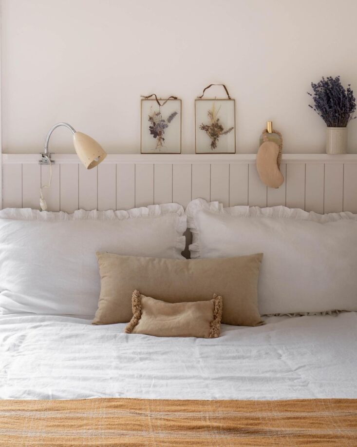 an eye mask hangs from a shelf above the bed in martina casonato’s  12