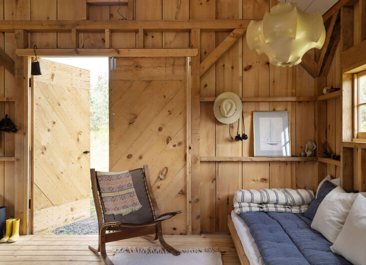 The living area opens right out onto the meadow by way of two large barn doors. Photograph by Matthew Williams for Remodelista: The Low-Impact Home.
