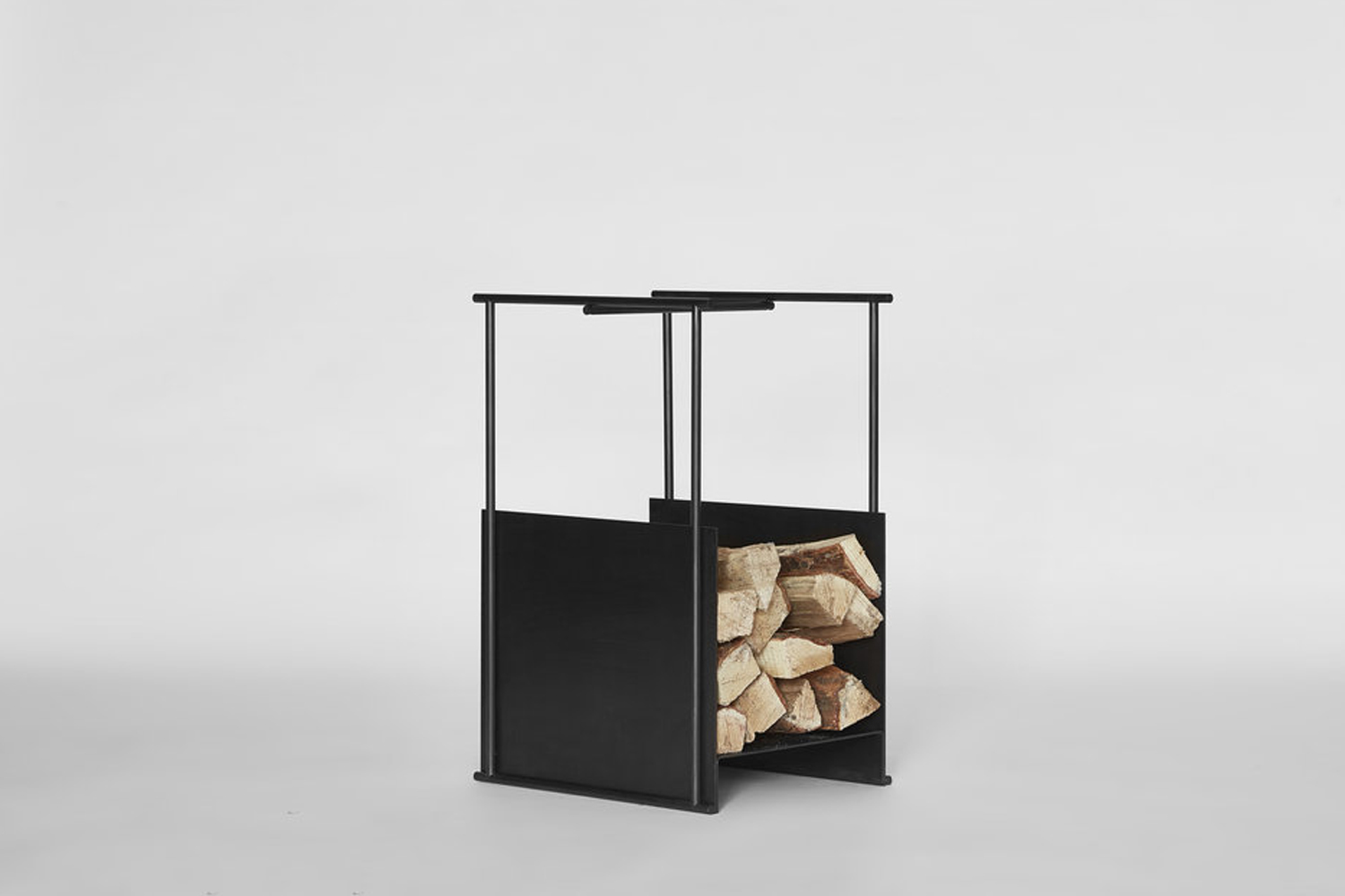 the black firewood hutch, designed by thom fougere for mjölk, is made of a 13