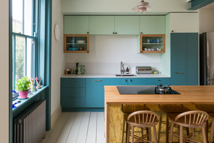 the kitchen is small, but color and materials define separate spaces between ca 9