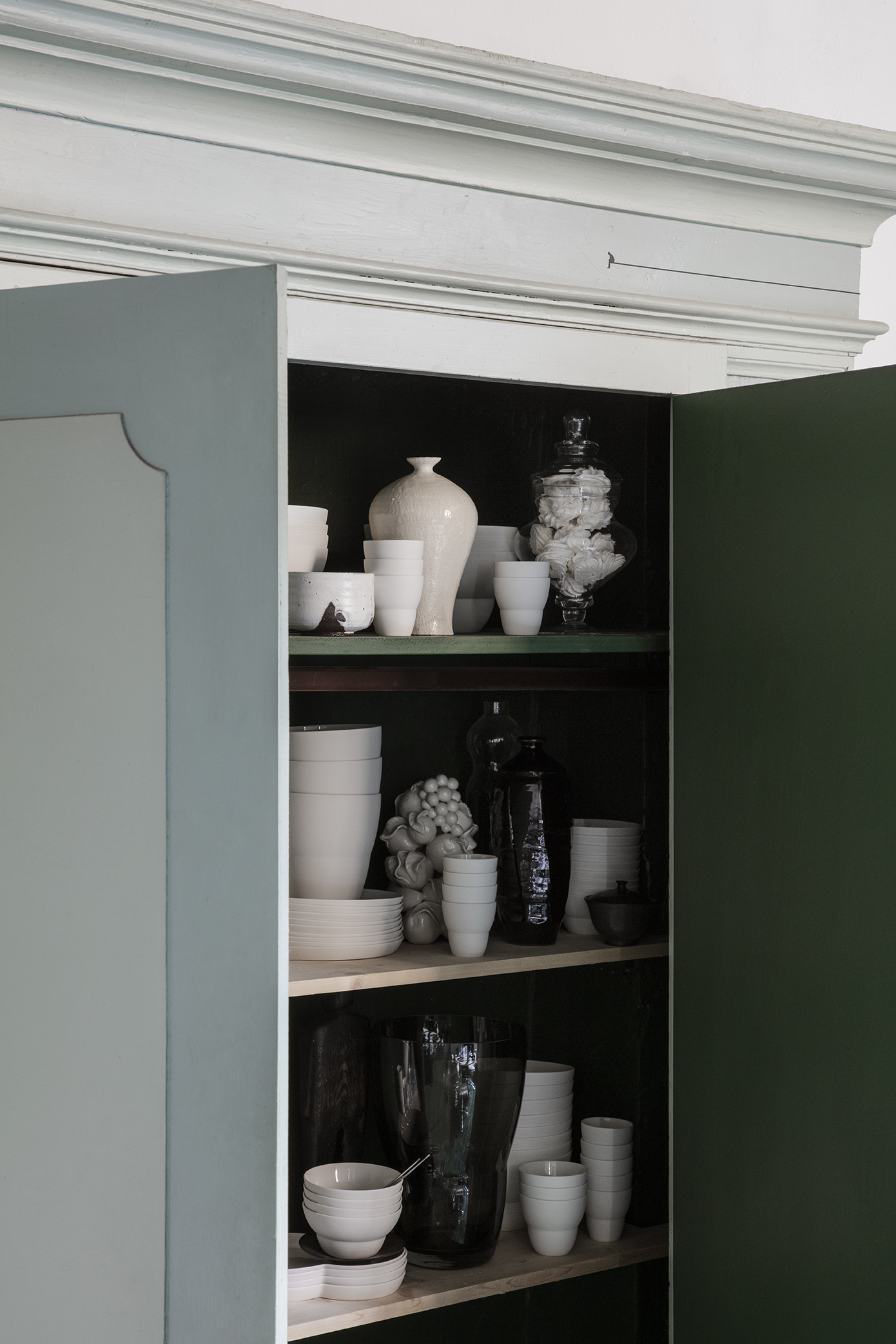 the cupboard is stocked with vipp tableware. 15