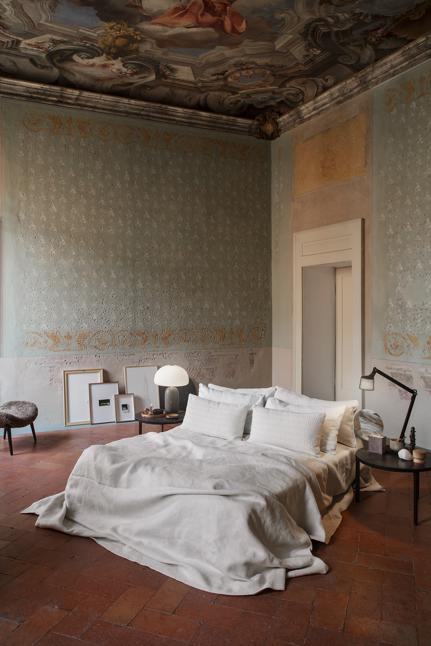 the bed is set on a terra cotta floor \10 feet under a baroque fresco. the beds 18