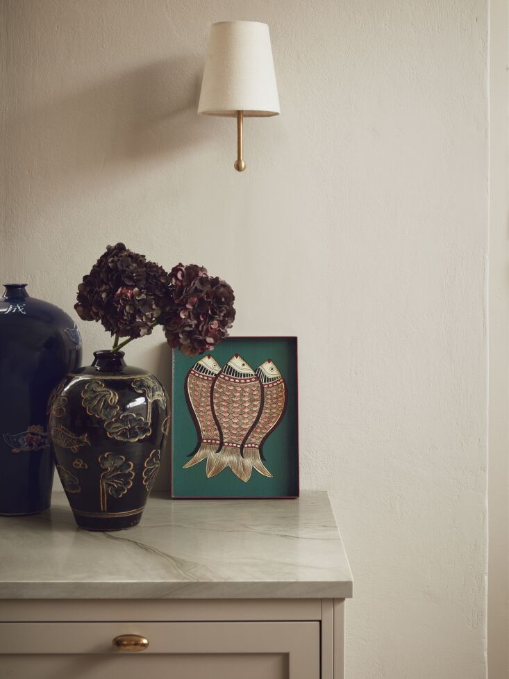 the sconce is the workstead house wall lamp in brass. placed up against the wal 12