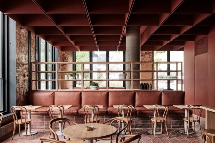 a cafe redone in brick red. see bentwood: an eatery in a former thonet showroom 22