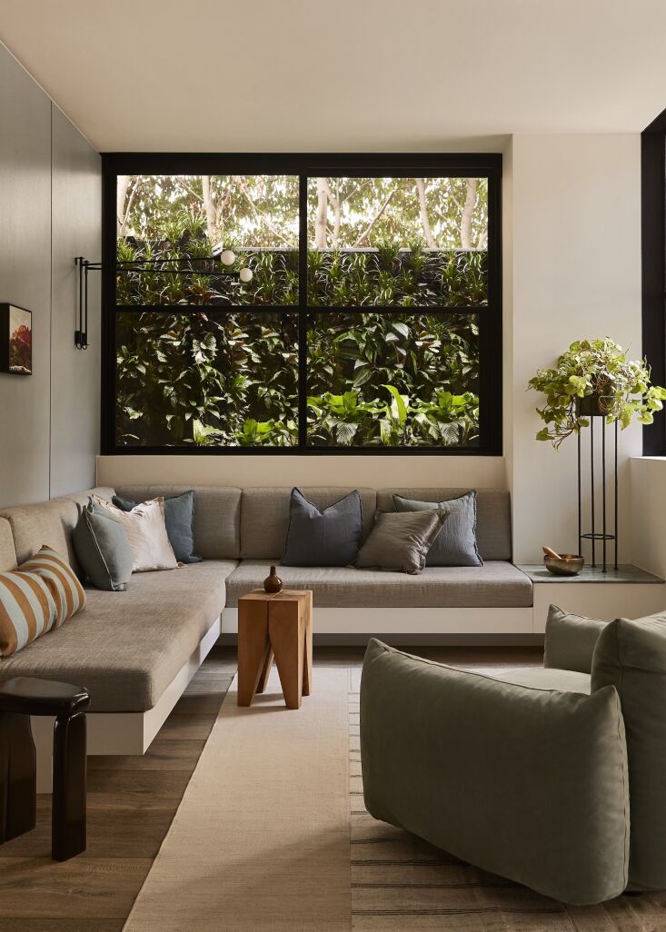 a wrap around sofa faces the garden in this project by designer brem perera; se 15