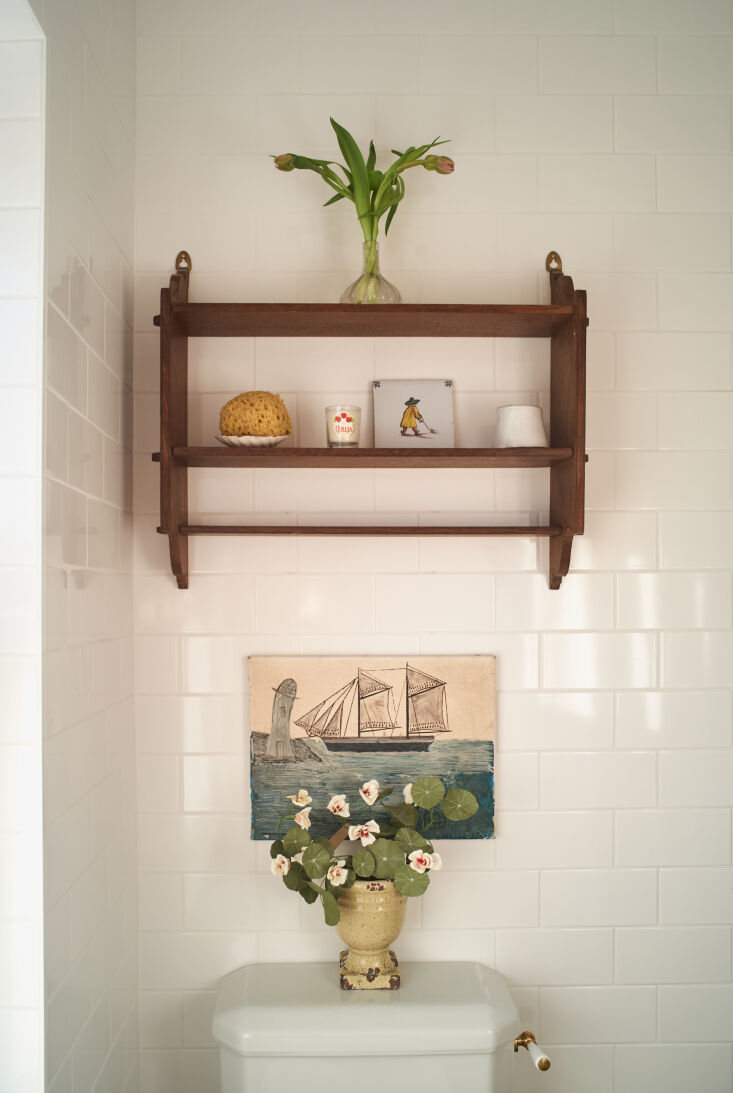 a charming tableau thanks to an antique wall shelf and vintage finds. the room  16