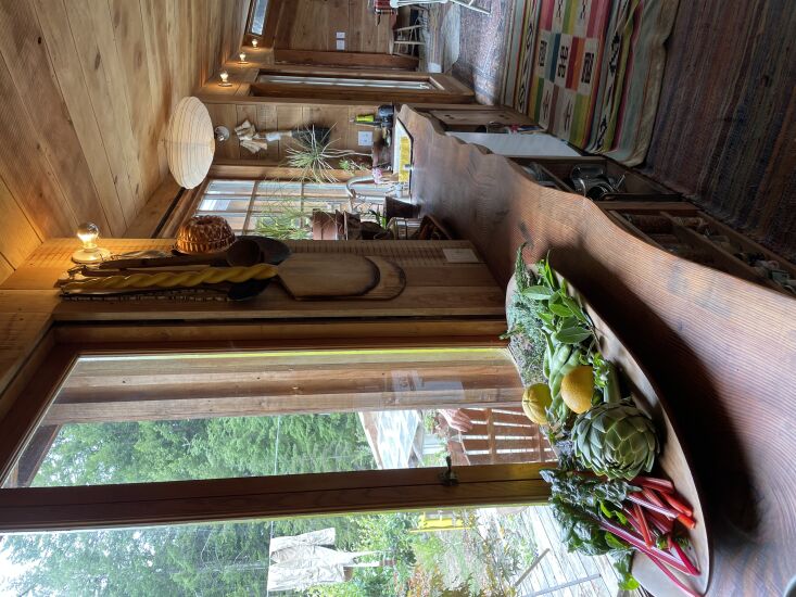 the kitchen, with a live edge counter and layered rugs. 23