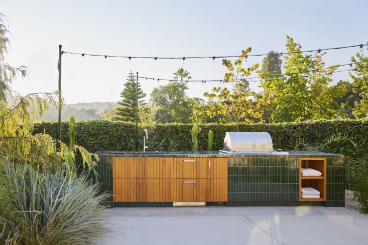 green heath tiles cover the outdoor kitchen designed by and and and studio. pho 20