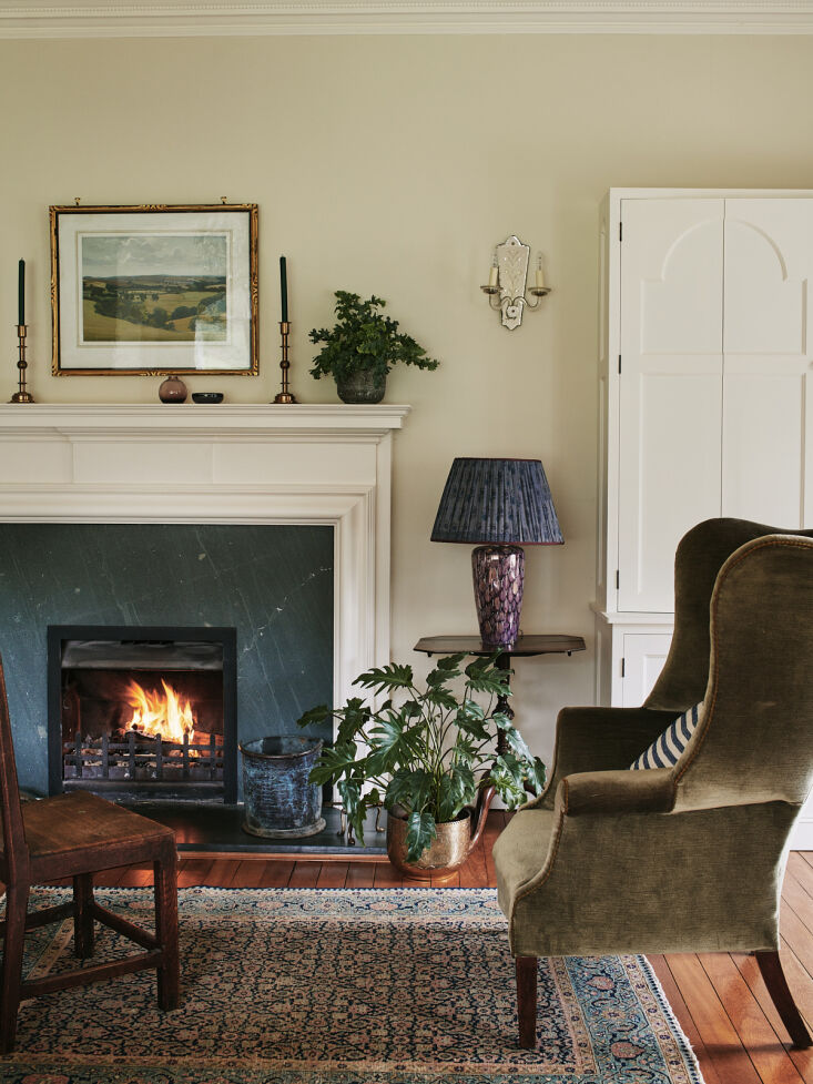 tamsin paired the original green granite fireplace with an olive velvet wingbac 19