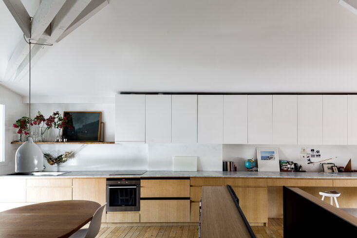 with a wall to wall carrara marble counter, the kitchen flows seamlessly into t 14