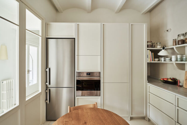 the other side of the eat in kitchen is built out with tall storage, a smeg wal 17