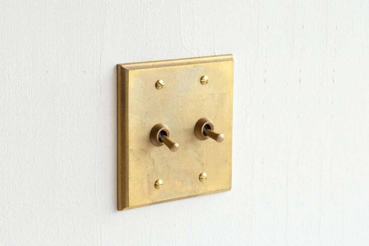 the switch plates are &#8220;outfitted with a brass toggle designed to be 15