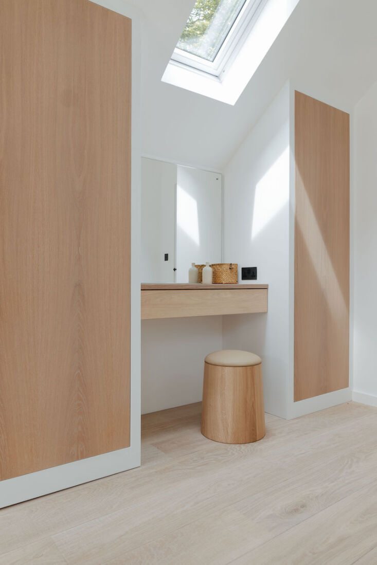 a naturally lit dressing nook in the main bedroom with bespoke cupboards and a  29