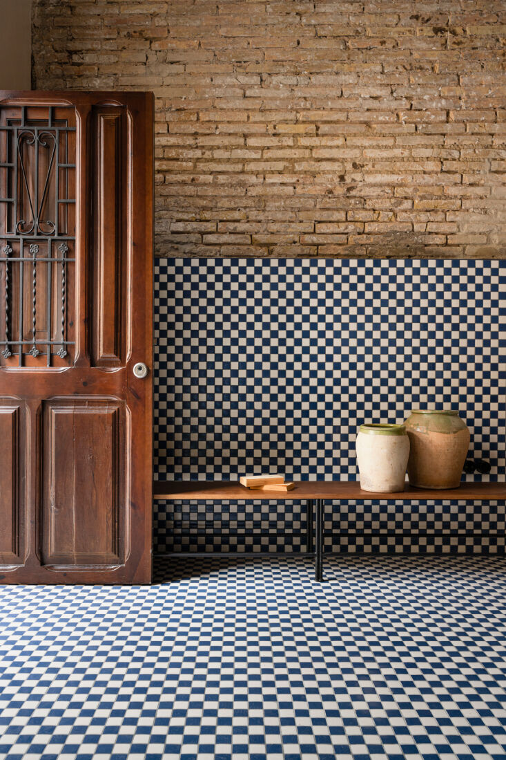 a marine blue and white checkerboard greets visitors to casa cabanyal, a 1946  14