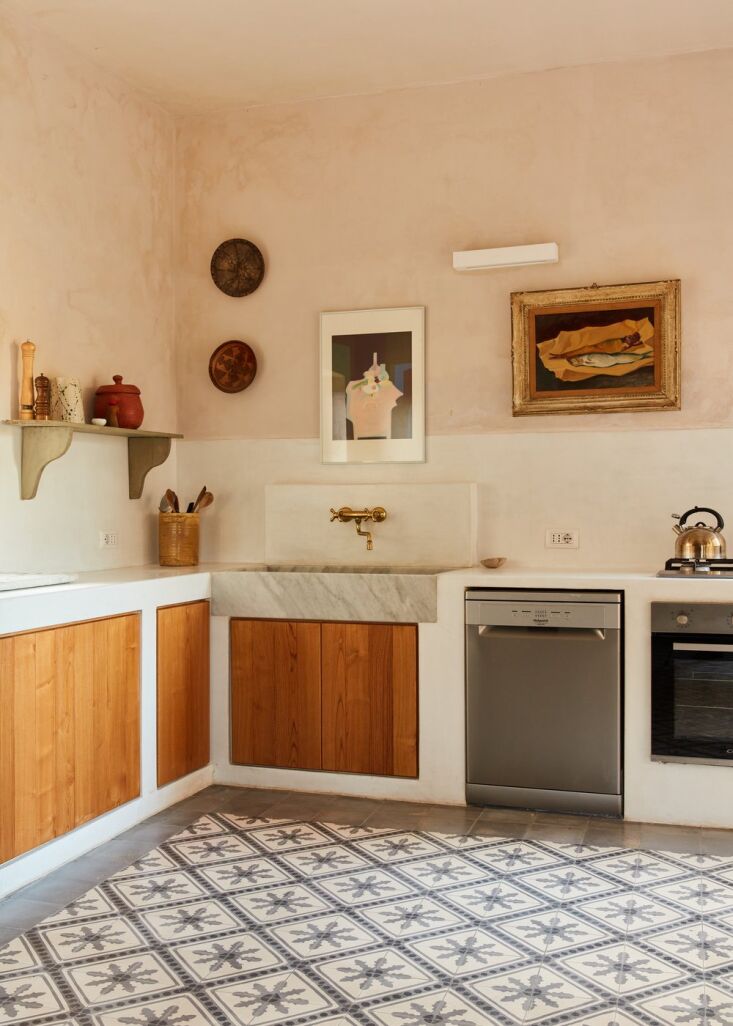 in il grande dammuso, the kitchen is an appealing mix of materials: concrete, w 15