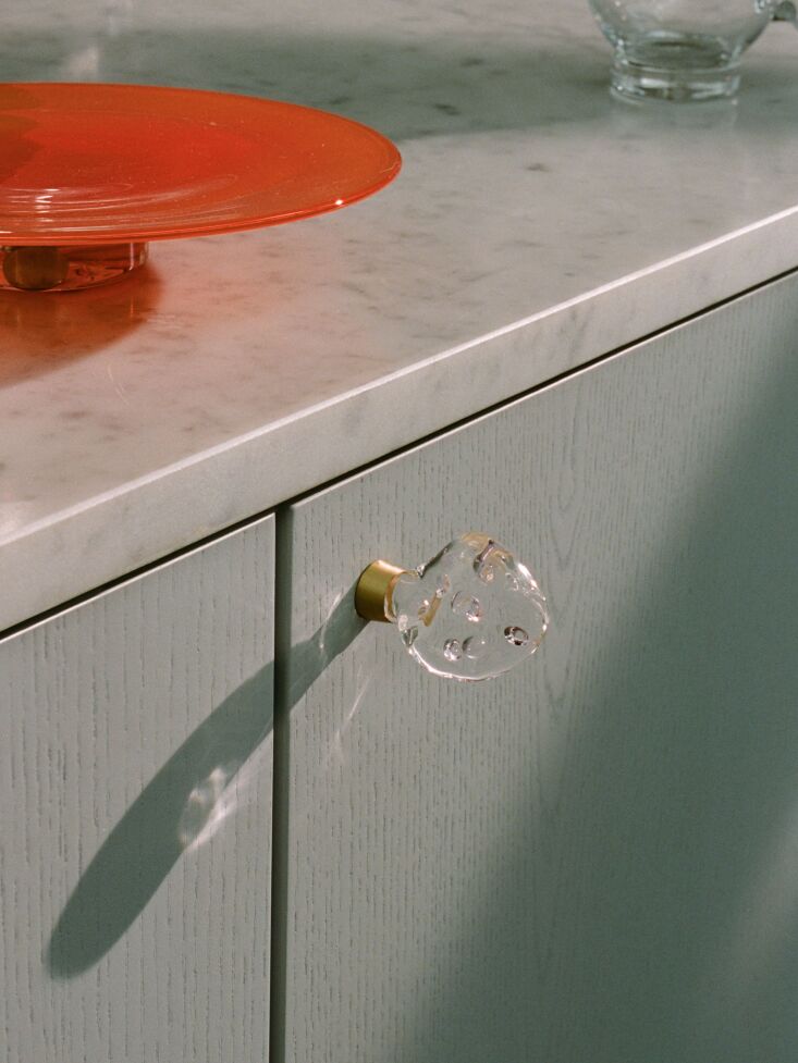 a detail of the mouth blown glass knobs and a brass base. 24