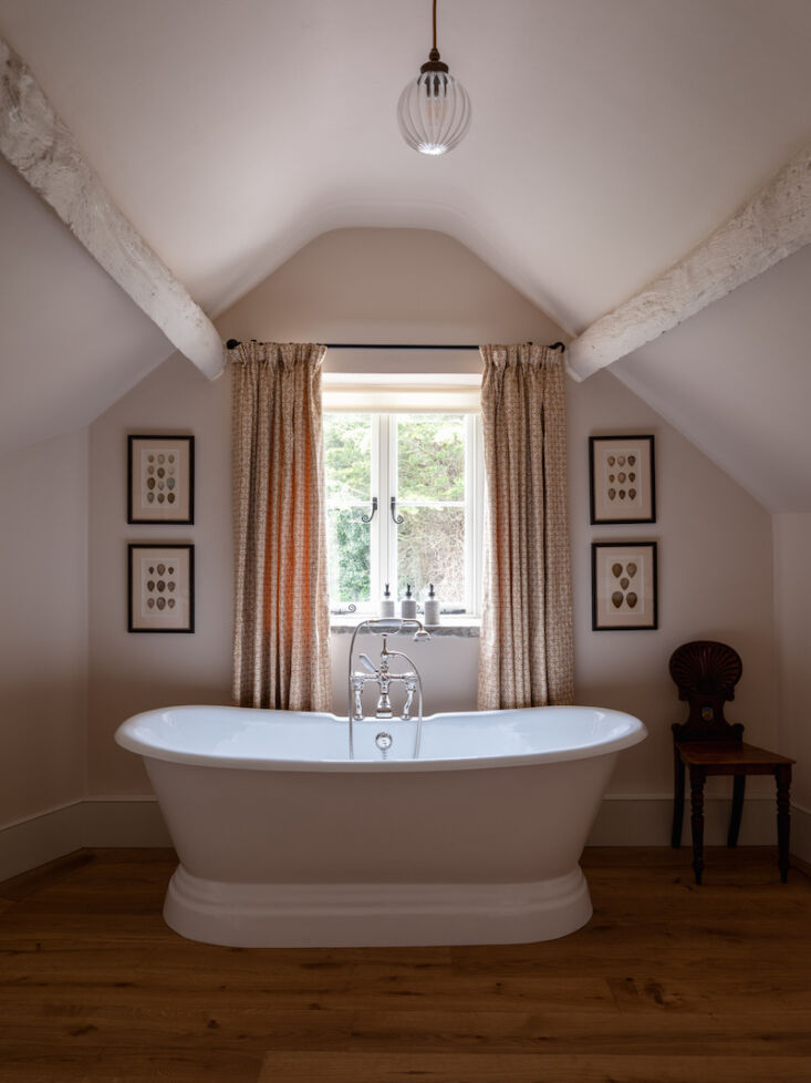 the ensuite baths, as with all of the guest rooms, is anchored with reclaimed a 13
