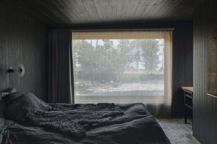 unabashed layers of black in the bedroom from walls and carpet down to the read 14