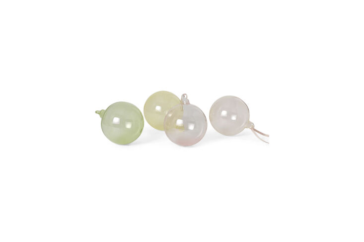 the ferm living set of four large glass baubles, shown in mixed light, is \$45  20