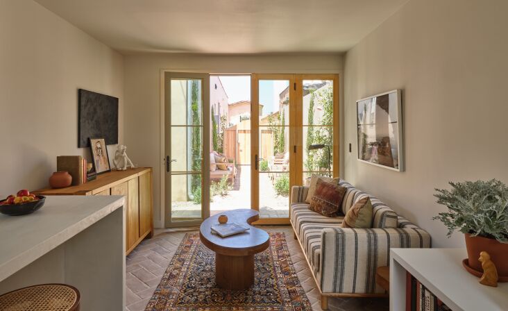 the french door entry opens off a side yard. the sofa and coffee table are from 16