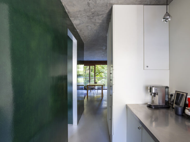 a view looking back into the open living and dining area. the door to the left  18