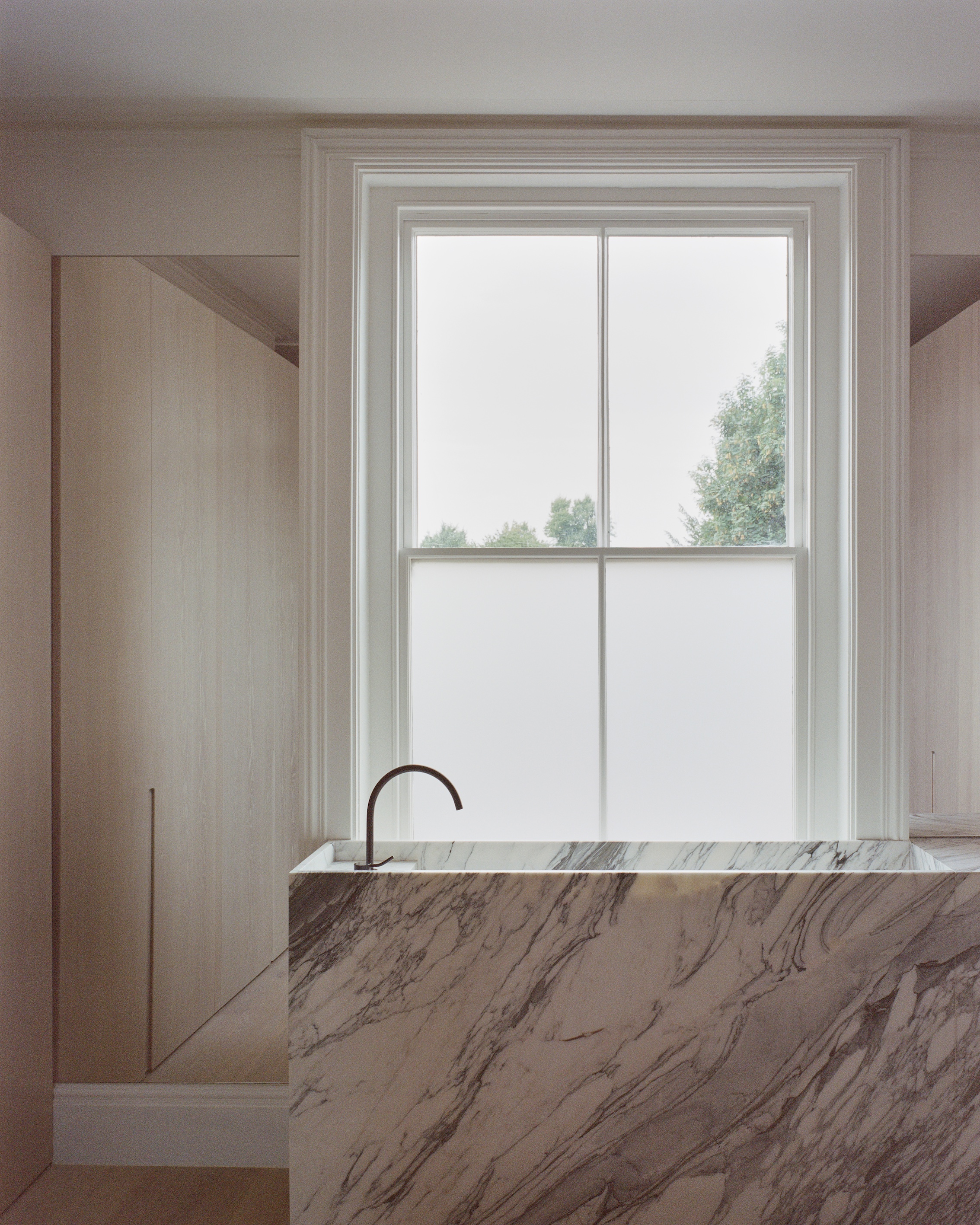 an arabescato corchia marble clad sink. note that in lieu of a window covering, 27