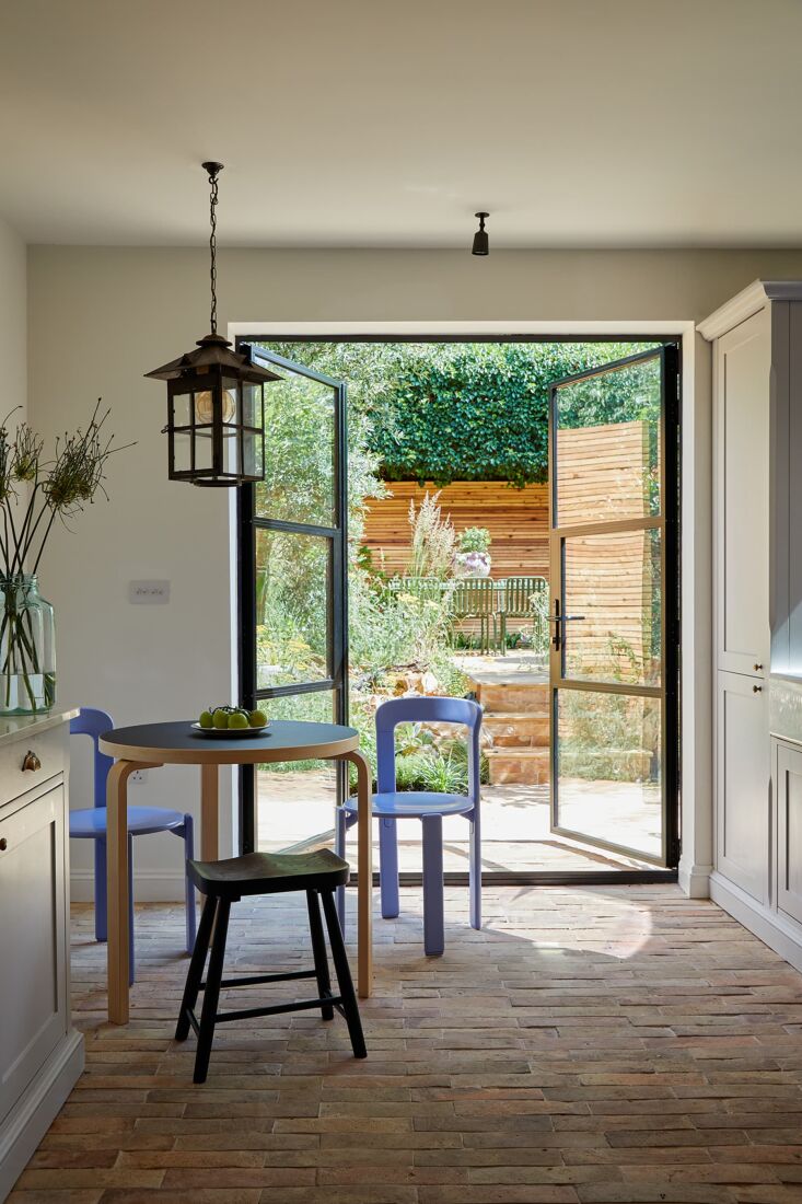 the kitchen ends with steel and glass french doors that lead to the patio. recl 24