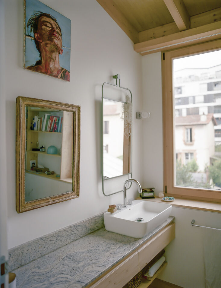 the bathroom is designed with 3 ply spruce storage and romanian marble to echo  32