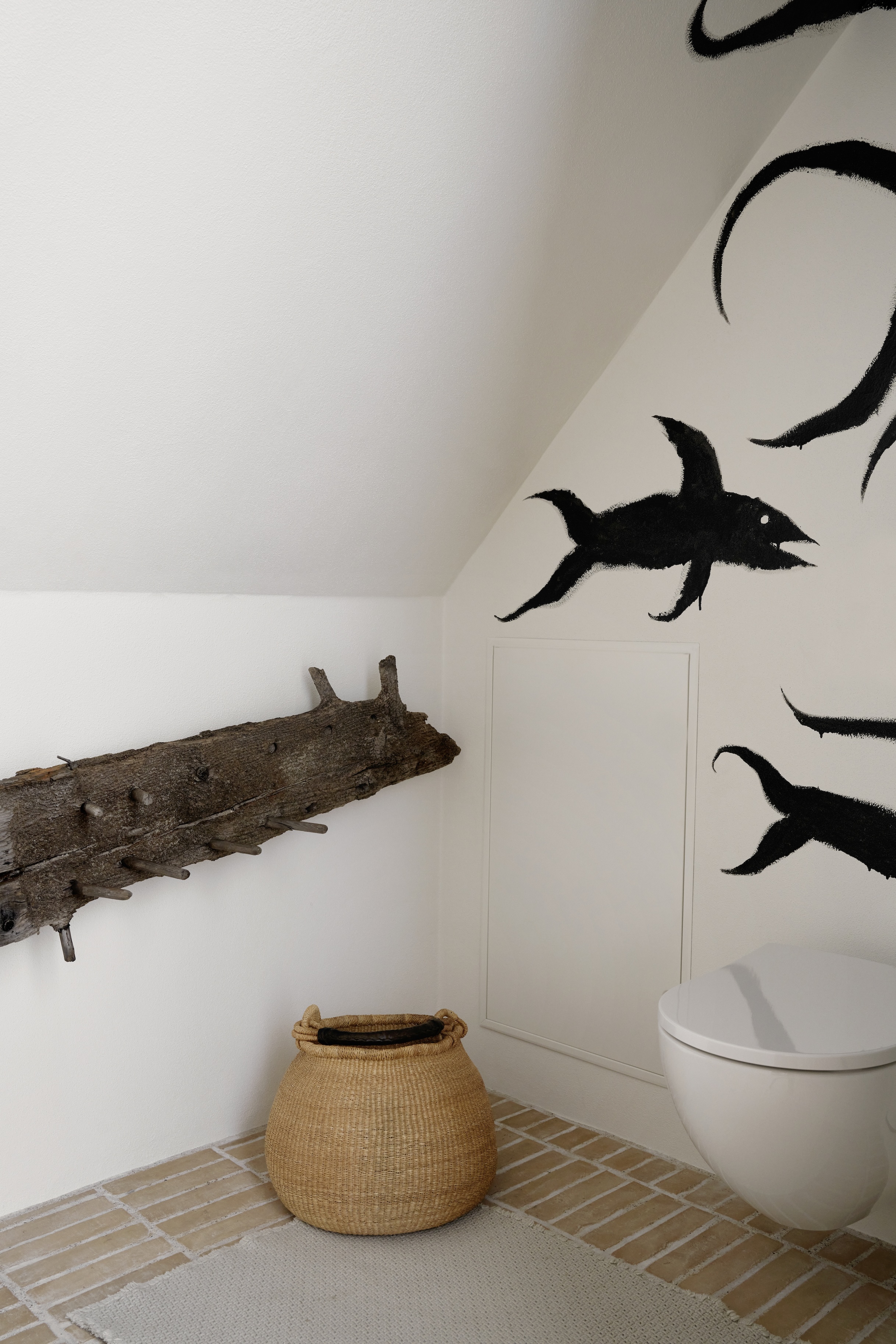 an old beam turned hanging rack meets a school of fish painted on the wall by a 30
