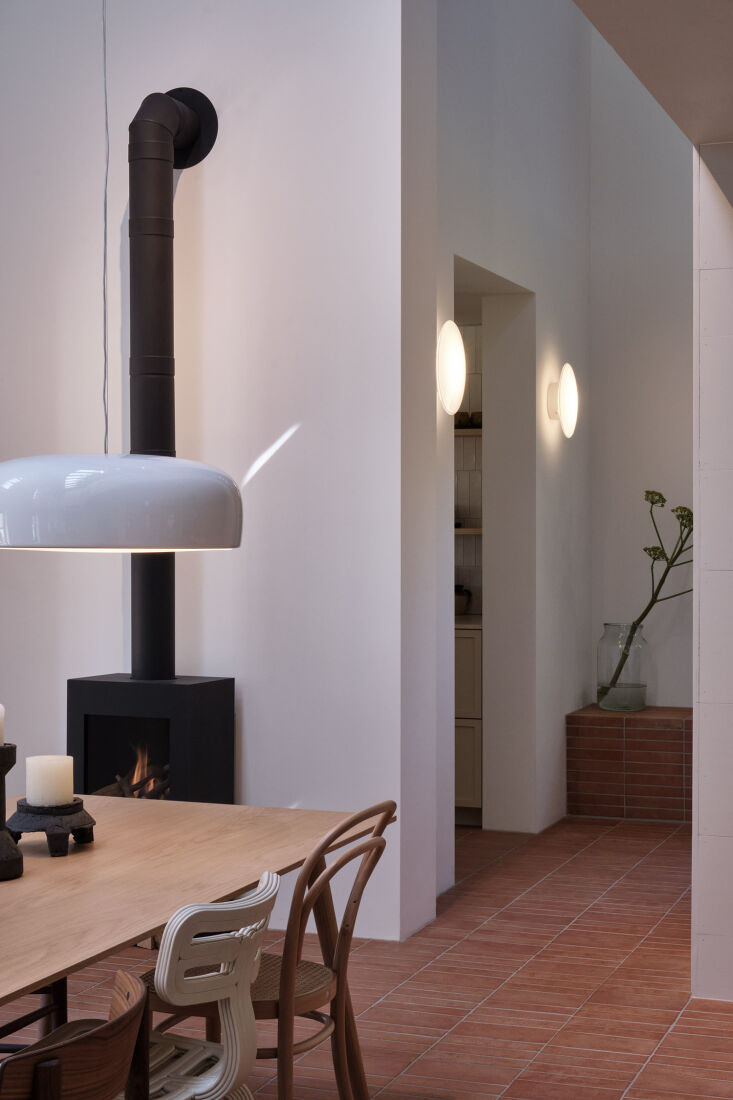 the entrance to the kitchen is flanked by aj eklipta wall lamps. 26