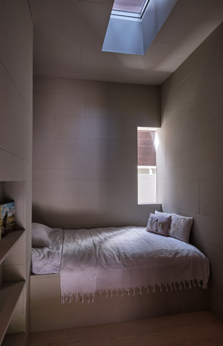a once lightless area is transformed into an efficient bedroom with light enter 25
