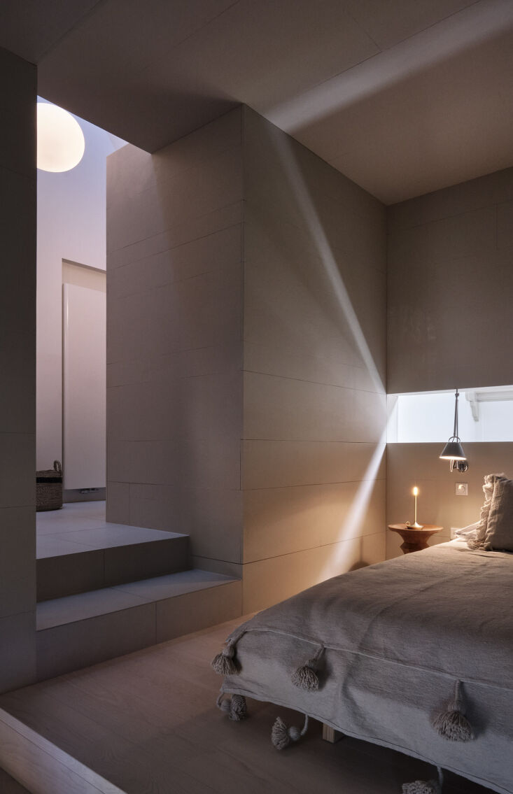 the main bedroom is designed with a tolomeo wall sconce and eames stool. 34